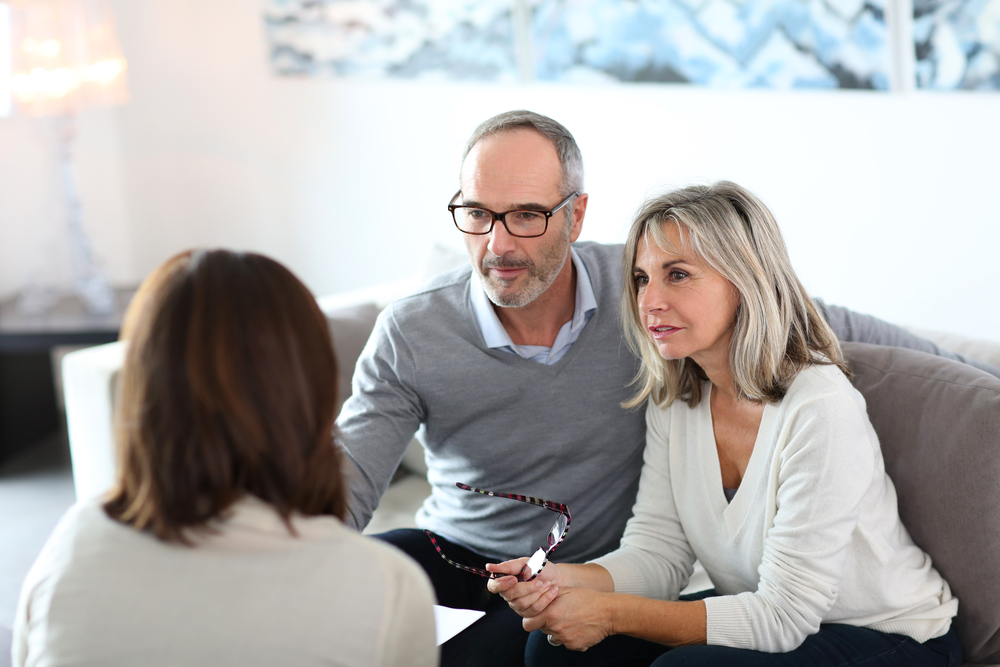 Senior couple meeting financial adviser for investment